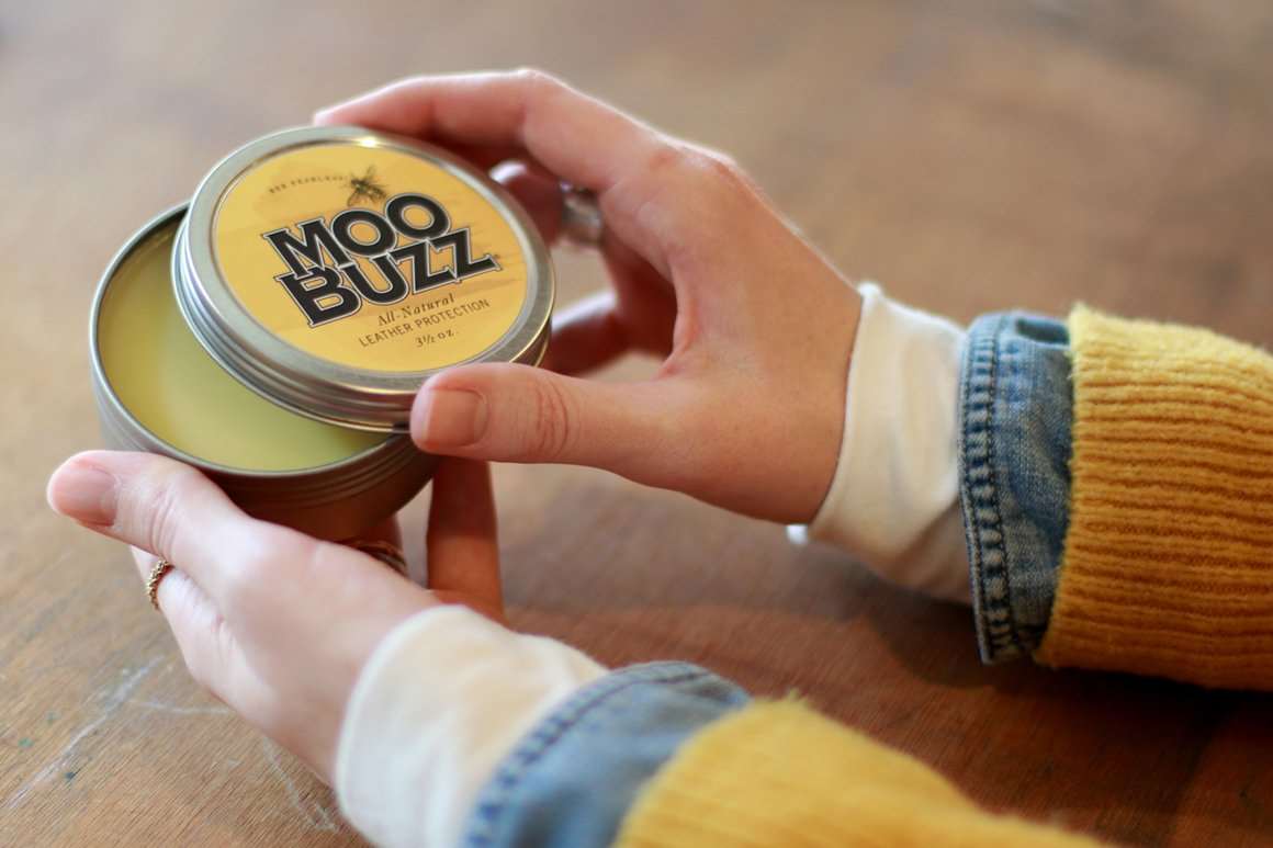 hands holding MooBuzz original tin