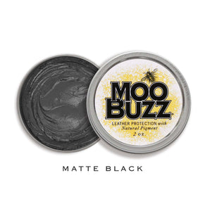 Open tin with MooBuzz logo and matte black product.